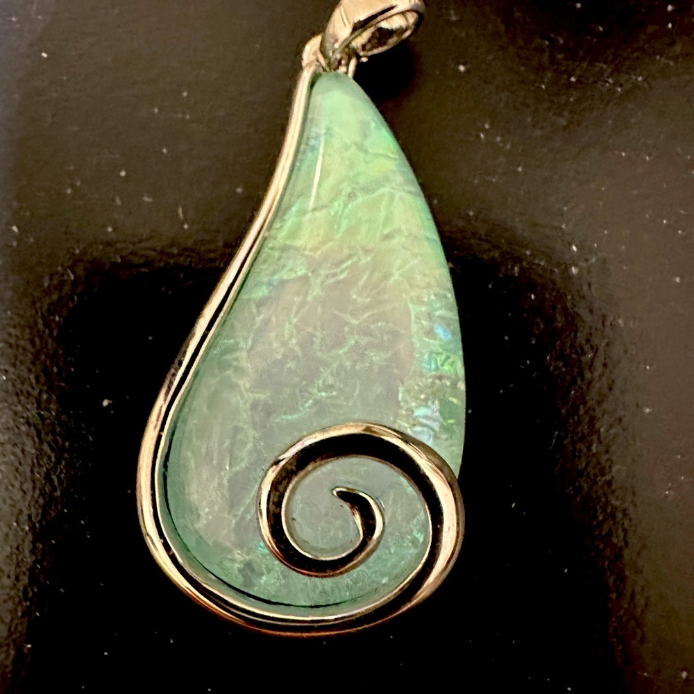 Charm with beautiful blue green stone.